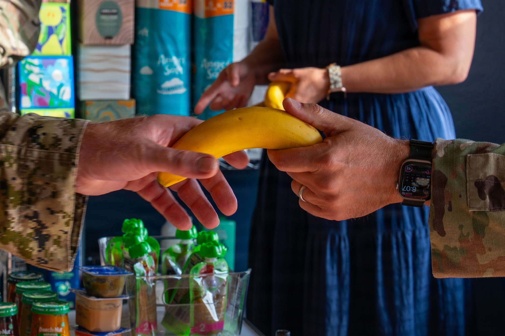 A hand holds a banana