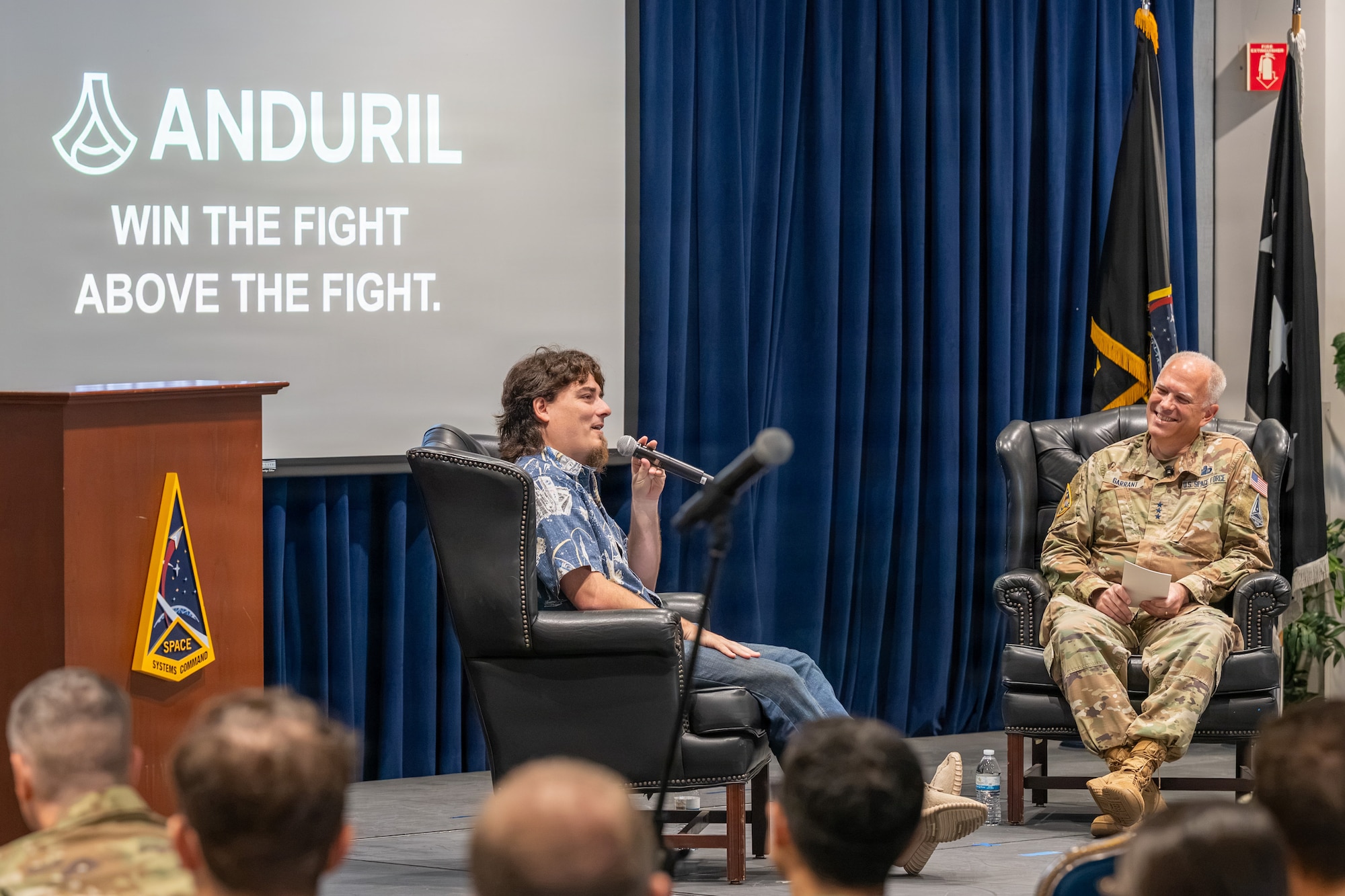 U.S. Space Force Lt. Gen. Philip Garrant, commander of Space Systems Command (SSC), right, speaks with Palmer Luckey, founder of Anduril Industries, during a “Guardians Everywhere” event at Los Angeles Air Force Base in El Segundo, California, August 6, 2026. SSC Guardians, Airmen, civilians and contractors joined the discussion which focused on innovation, leadership mindset and the role of emerging technologies in strengthening national security and space domain awareness. (U.S. Space Force photo by Christopher Kim)