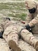 A U.S. service member practices administering the Advanced Anticonvulsant System via "buddy aid" during a training drill.
