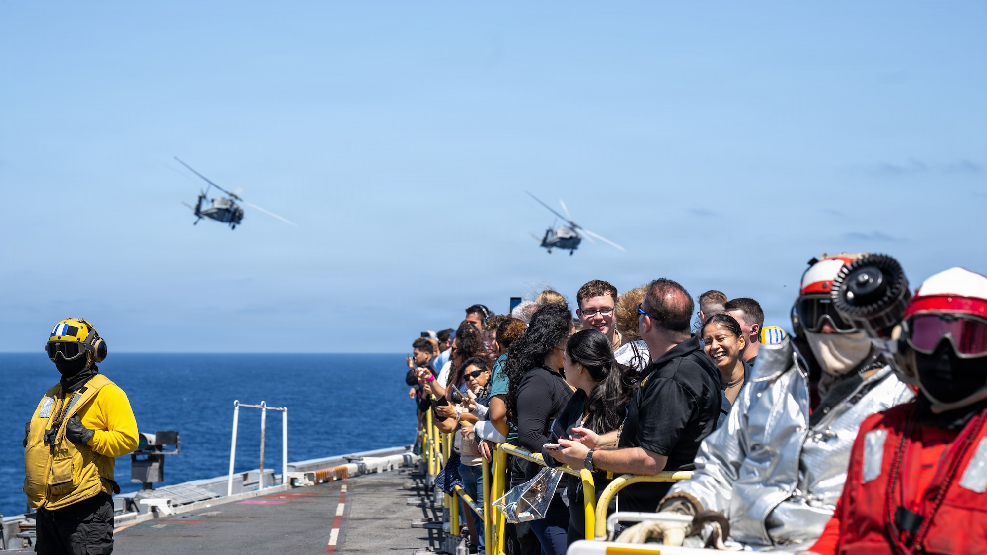 Friends and family members of Sailors assigned to Nimitz-class aircraft carrier USS Theodore Roosevelt (CVN 71) watch an air show on the flight deck, Aug. 8, 2026. Theodore Roosevelt’s friends and family day cruise showcases carrier strike group capabilities and the professionalism of the crew. (U.S. Navy photo by Mass Communication Specialist 2nd Class Aaron Haro Gonzalez)