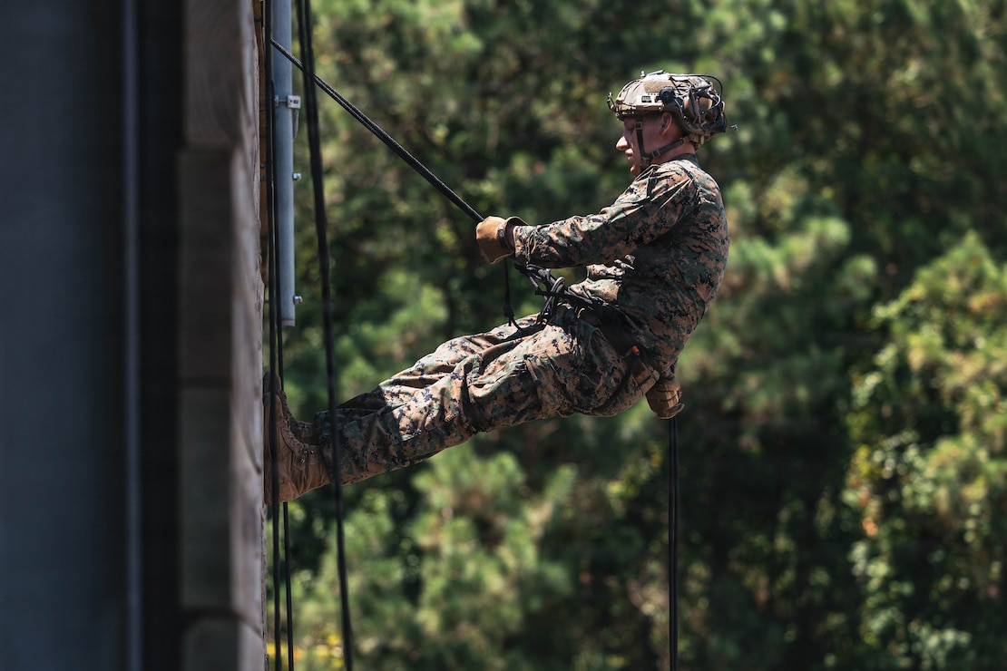 U.S. Marine Corps Sgt. Jackson Olson, an assistant team leader with 2nd Reconnaissance Battalion and Wisconsin native, rappels down a training structure during a helicopter rope suspension techniques course on Marine Corps Base Camp Lejeune, North Carolina, July 15, 2026. The HRST training prepares Marines to navigate difficult terrain and insert rapidly into contested areas through rappelling and fast-rope descents. (U.S. Marine Corps photo by Sgt. Jorge Borjas)