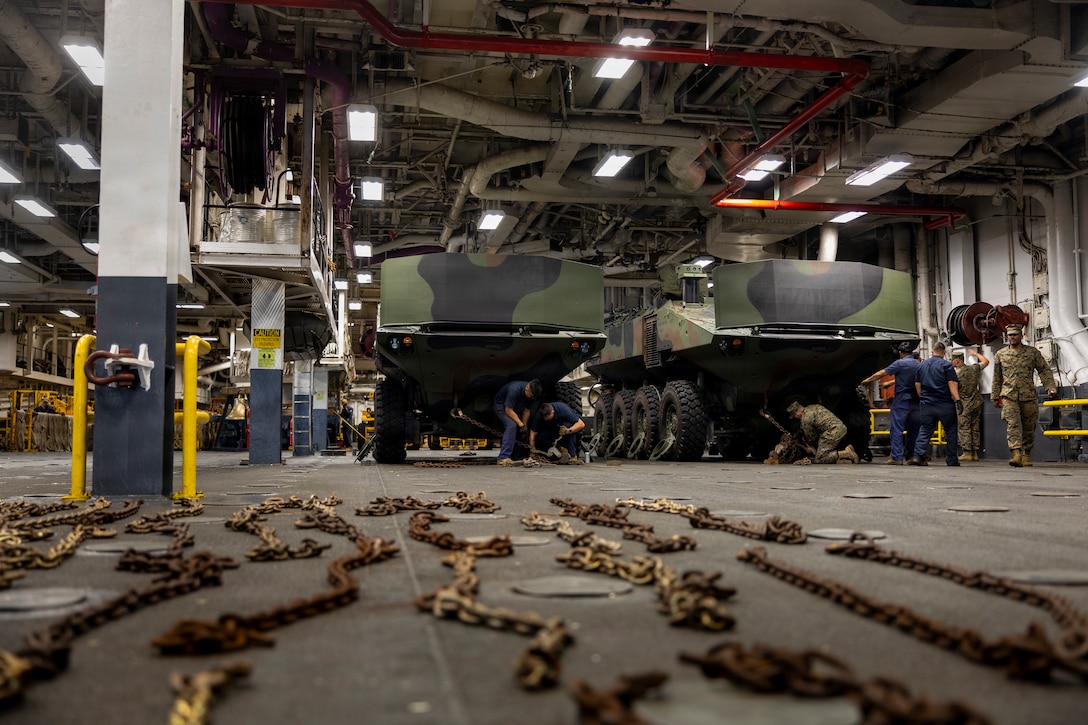 U.S. Marines assigned to the 2d Assault Amphibian Battalion chain down amphibious combat vehicles while aboard amphibious assault ship USS Kearsarge (LHD 3) during 26th Marine Expeditionary Unit’s Type Commanders Amphibious Training (TCAT) while pierside Naval Station Norfolk, Virginia, June 9, 2026. TCAT is a military exercise designed to enhance mobility and integration between the U.S. Marine Corps and the U.S. Navy. The training focuses on improving the necessary skills for real-world operations and effective collaboration between Marine Corps and Naval teams. (U.S. Marine Corps photo by Cpl. Matthew Williams)