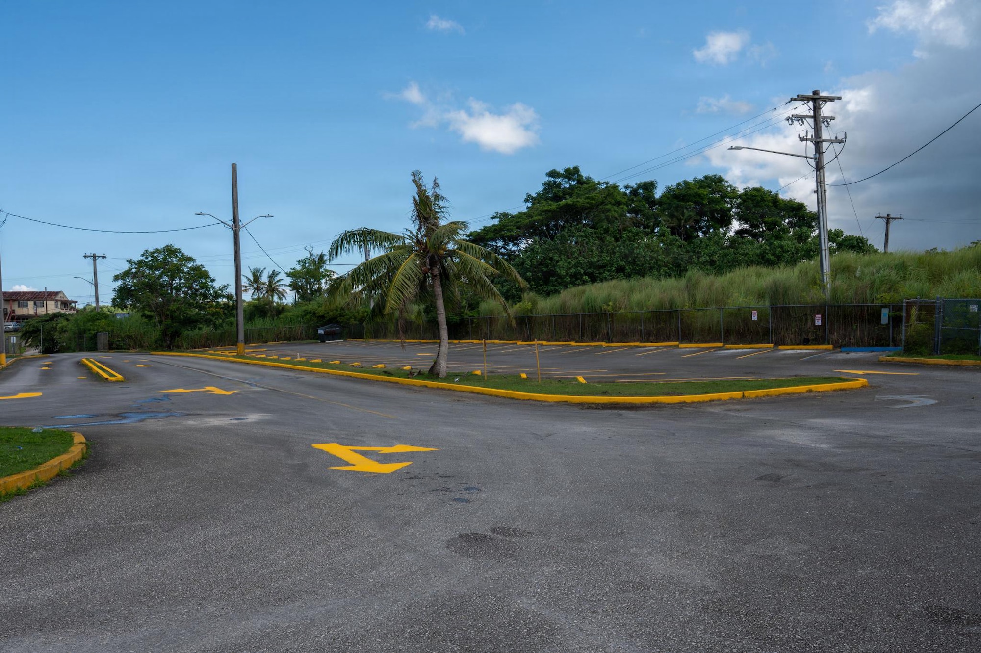 A school parking lot is cleared and repainted by Airmen assigned to the 21st Air Task Force at Mongmong-Toto-Maite, Guam, July 1, 2026. Volunteer projects improved school facilities while reinforcing the 21st ATF’s commitment to serving local communities through partnership and engagement. (U.S. Air Force photo by Senior Airman Alondra Cristobal Hernandez)