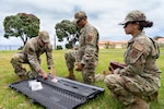 U.S. Air National Guard Airman 1st Class Maria Del Carmen Dominguez, right, an engineering assistant with the 142nd Civil Engineer Squadron, observes fellow civil engineers assembling a dynamic cone penetrometer during a Deployment for Training, or DFT, at Lajes Air Base, Portugal, June 23, 2026.