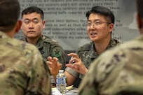 Republic of Korea Army Maj. Kyung Hyun Ko, ROKA Planning Department budget officer, center right, asks a question to U.S. Army Master Sgt. Jeong Jin, U.S. Army Financial Management Command Strategic Initiatives Group noncommissioned officer in charge, far left, as ROKA Capt. Jae Young Heo, ROKA Consolidated Administration School governmental accounting instructor, center left, and U.S. Army Command Sgt. Maj. Joy L. Allen, USAFMCOM senior enlisted advisor, far right, listen at the Maj. Gen. Emmett J. Bean Federal Center in Indianapolis July 9, 2026. The ROKA finance officers visited USAFMCOM after a trip to the Office of the Assistant Secretary of the Army for Financial Management and Comptroller at the Pentagon and before heading to the U.S. Army Finance and Comptroller School at Fort Jackson, S.C., where they learned about the structure and operations of the U.S. Army Finance Corps. (U.S. Army photo by Mark R. W. Orders-Woempner)