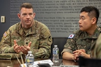 U.S. Army Lt. Col. Kevin P. Weaver, 45th Finance Center deputy director, left, explains U.S. Army financial operations as Republic of Korea Army Capt. Jae Young Heo, ROKA Consolidated Administration School governmental accounting instructor, listens at the Maj. Gen. Emmett J. Bean Federal Center in Indianapolis July 9, 2026. The ROKA finance officers visited USAFMCOM after a trip to the Office of the Assistant Secretary of the Army for Financial Management and Comptroller at the Pentagon and before heading to the U.S. Army Finance and Comptroller School at Fort Jackson, S.C., where they learned about the structure and operations of the U.S. Army Finance Corps. (U.S. Army photo by Mark R. W. Orders-Woempner)