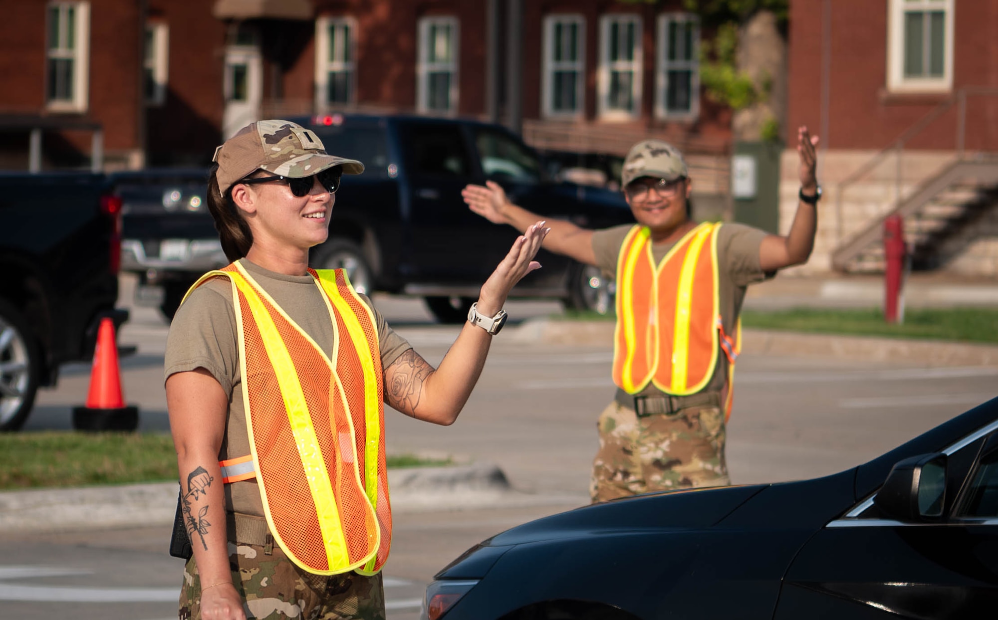 U.S. Air Force service members guide vehicles toward the parking area during the 2026 Defenders of Freedom Air & Space Show at Offutt Air Force Base, Nebraska, Aug. 9, 2026. Defenders of Freedom Air & Space Show 2026 served as a free, public open house to foster
strong community relations and express appreciation to the local Greater Omaha community. (U.S. Air Force photo by Daniel Martinez)