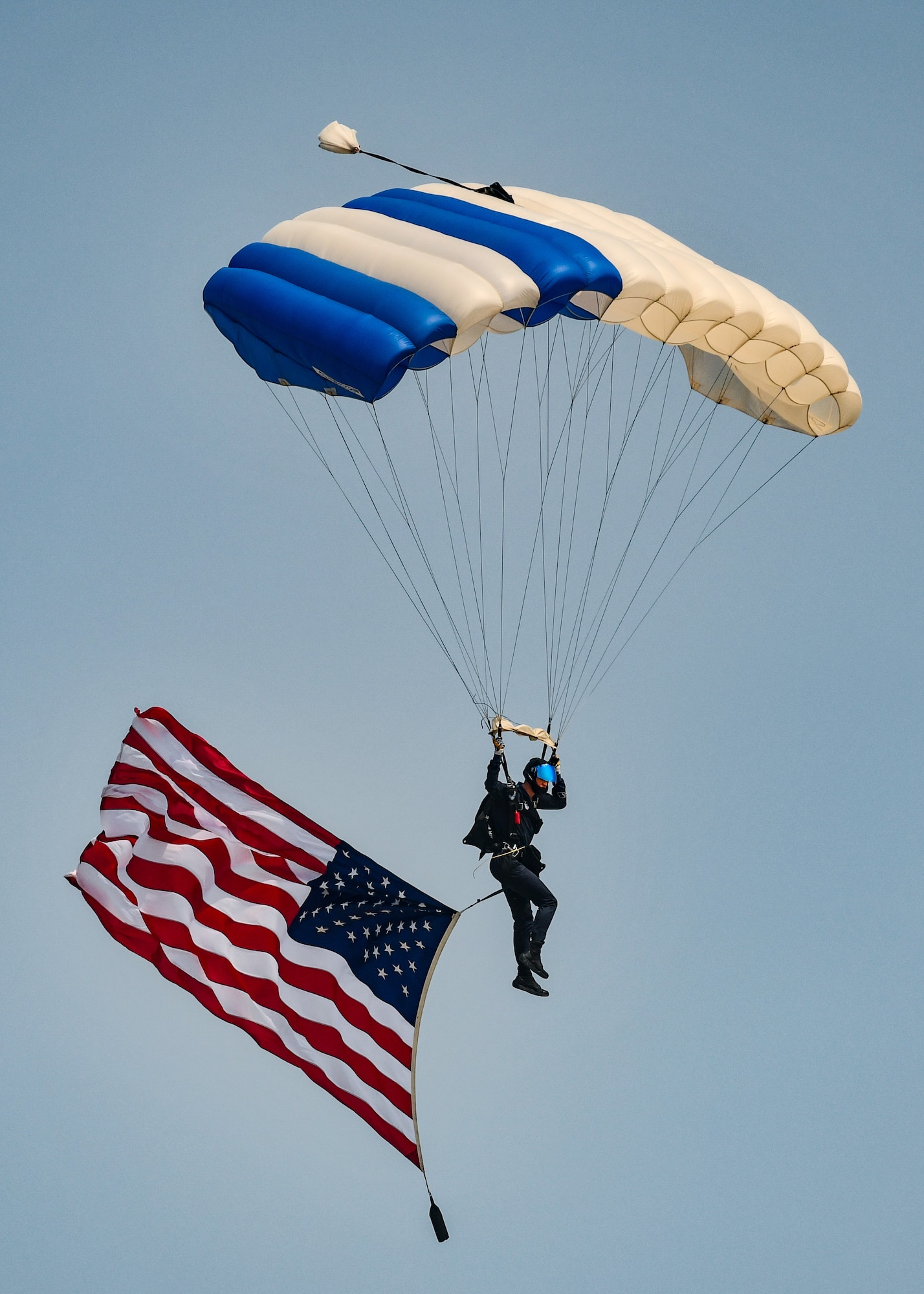U.S. Air Force Academy Wings of Blue parachuting team performs canopy maneuvers during the 2026 Defenders of Freedom Air & Space Show at Offutt Air Force Base, Nebraska, August 8, 2026. In alignment with the nationwide 'Freedom 250' celebration, the air show highlighted two and a half centuries of American progress, liberty, and the technological leaps made throughout military aviation history. (U.S. Air Force photo by Chad Watkins)