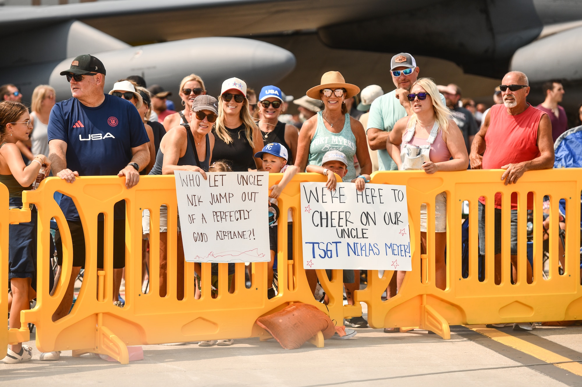 A crowd hold signs for Technical Sgt. Niklas Meyer, jump master for the USAF Wings of Blue, during the 2026 Defenders of Freedom Air & Space Show at Offutt Air Force Base, Nebraska, Aug. 8,
2026. TSgt. Meyer originally hails from Omaha. (U.S. Air Force photo by Chad Watkins)