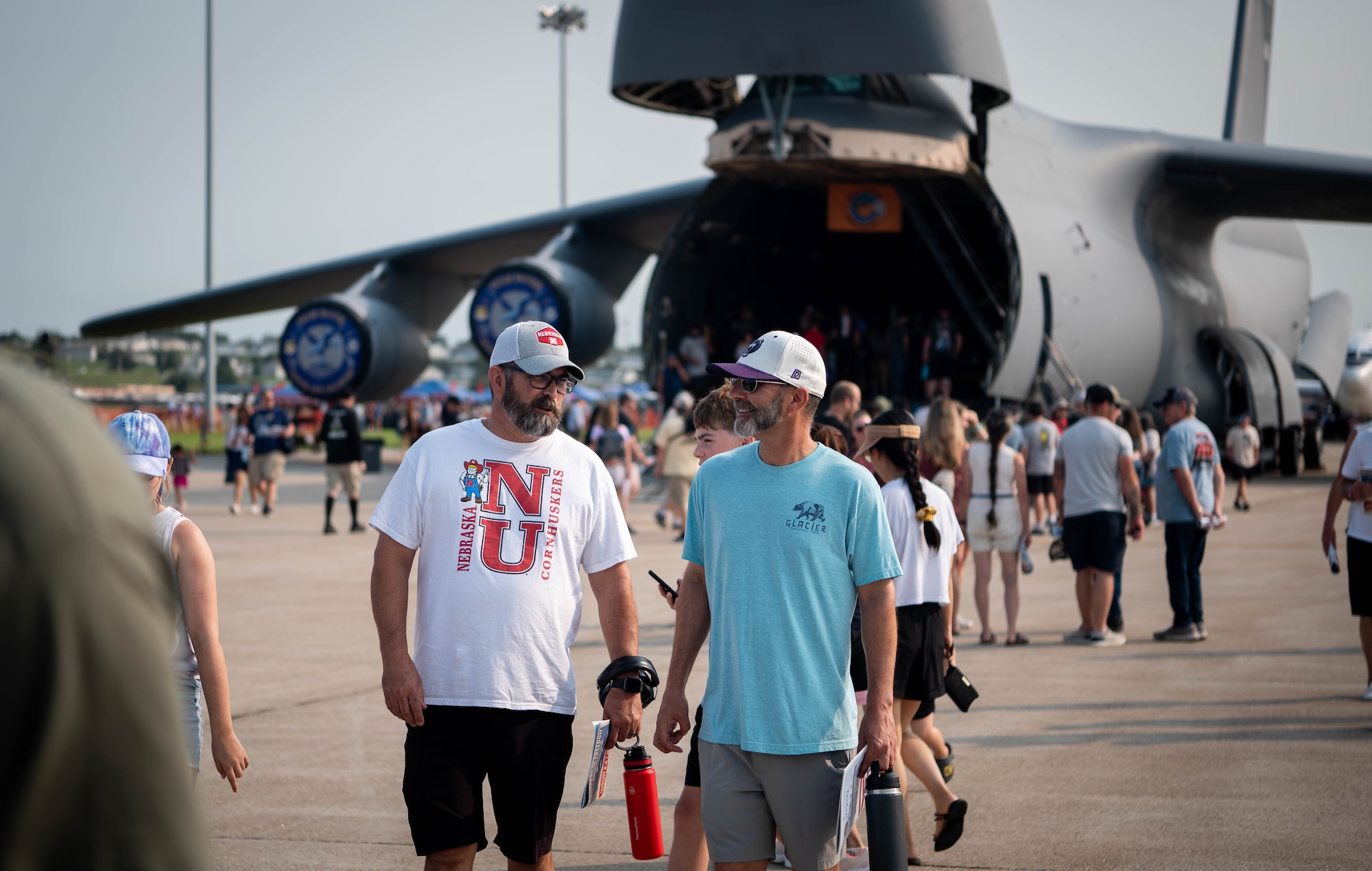 Local community stroll on the flightline during the 2026 Defenders of Freedom Air & Space Show at Offutt Air Force Base, Nebraska, Aug. 8, 2026. The event served as a platform to celebrate Offutt AFB's military heritage, honoring the unique civilian-military bond with the Greater Omaha community that has supported the nation's defense for generations. (U.S. Air Force photo by Daniel Martinez)