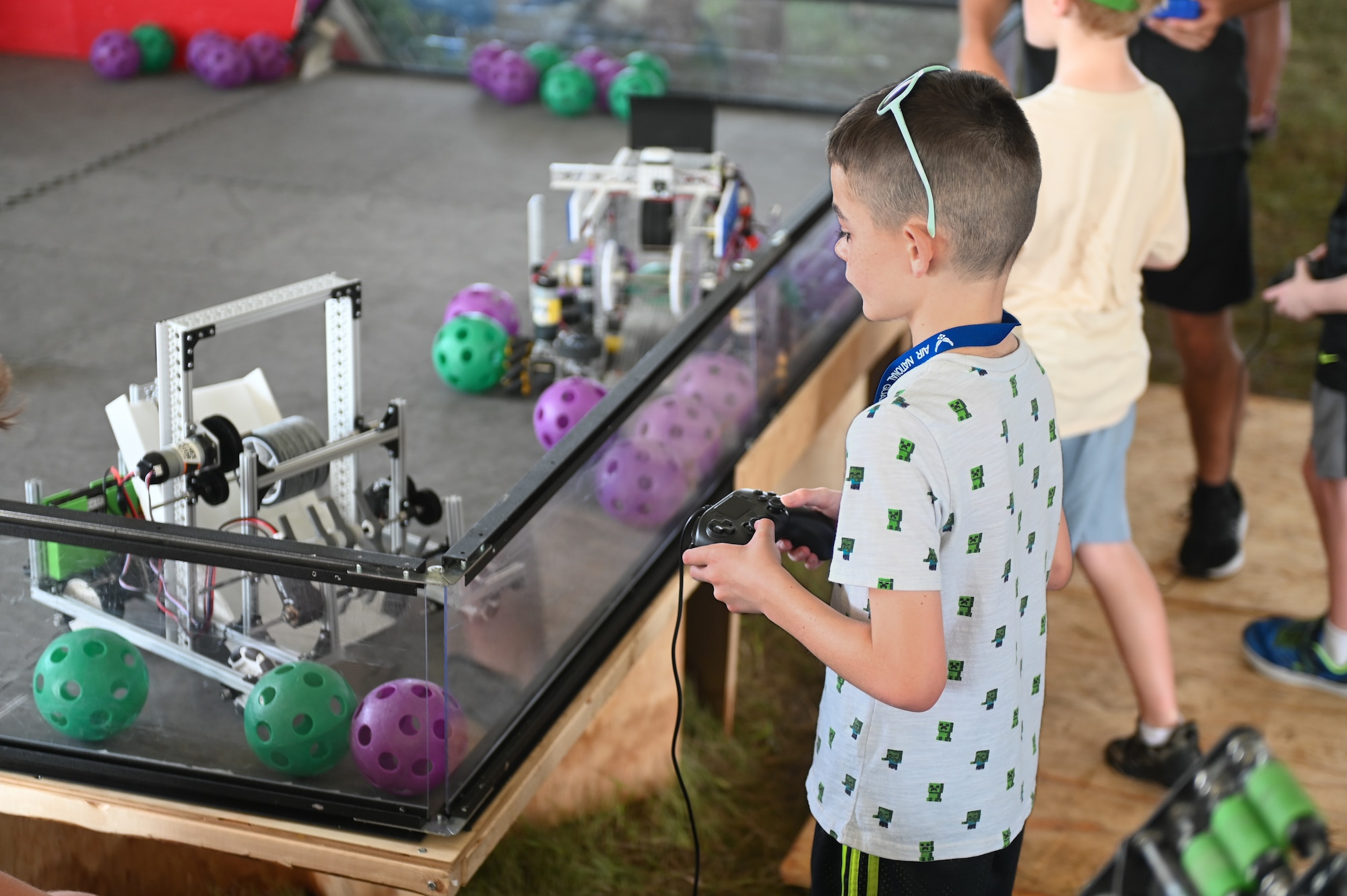 A young spectator experiences the Science, Technology, Engineering, and Mathematics vendor during the 2026 Defenders of Freedom Air & Space Show at Offutt Air Force Base, Nebraska, Aug. 9, 2026. Defenders of Freedom Air & Space Show 2026 was designed to educate the public on the strategic importance of Offutt AFB and the many worldwide missions it supports, providing a firsthand look at the advanced aircraft and highly trained personnel required to execute operations globally. (U.S. Air Force Photo by Airman 1st Class Charles Bolden)