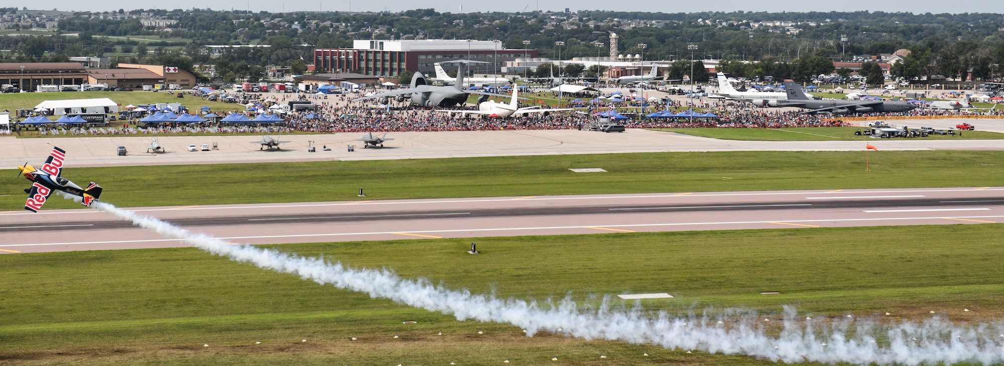 Kevin Coleman performs an aerobatic maneuver in his Red Bull plane during the 2026 Defenders of Freedom Air & Space Show at Offutt Air Force Base, Nebraska, Aug. 9, 2026. The biennial air show served as a key community outreach event, aiming to inspire the next generation of aviators by highlighting the diverse career paths and unwavering dedication of today's Airmen. (U.S. Air Force photo by Chad Watkins)