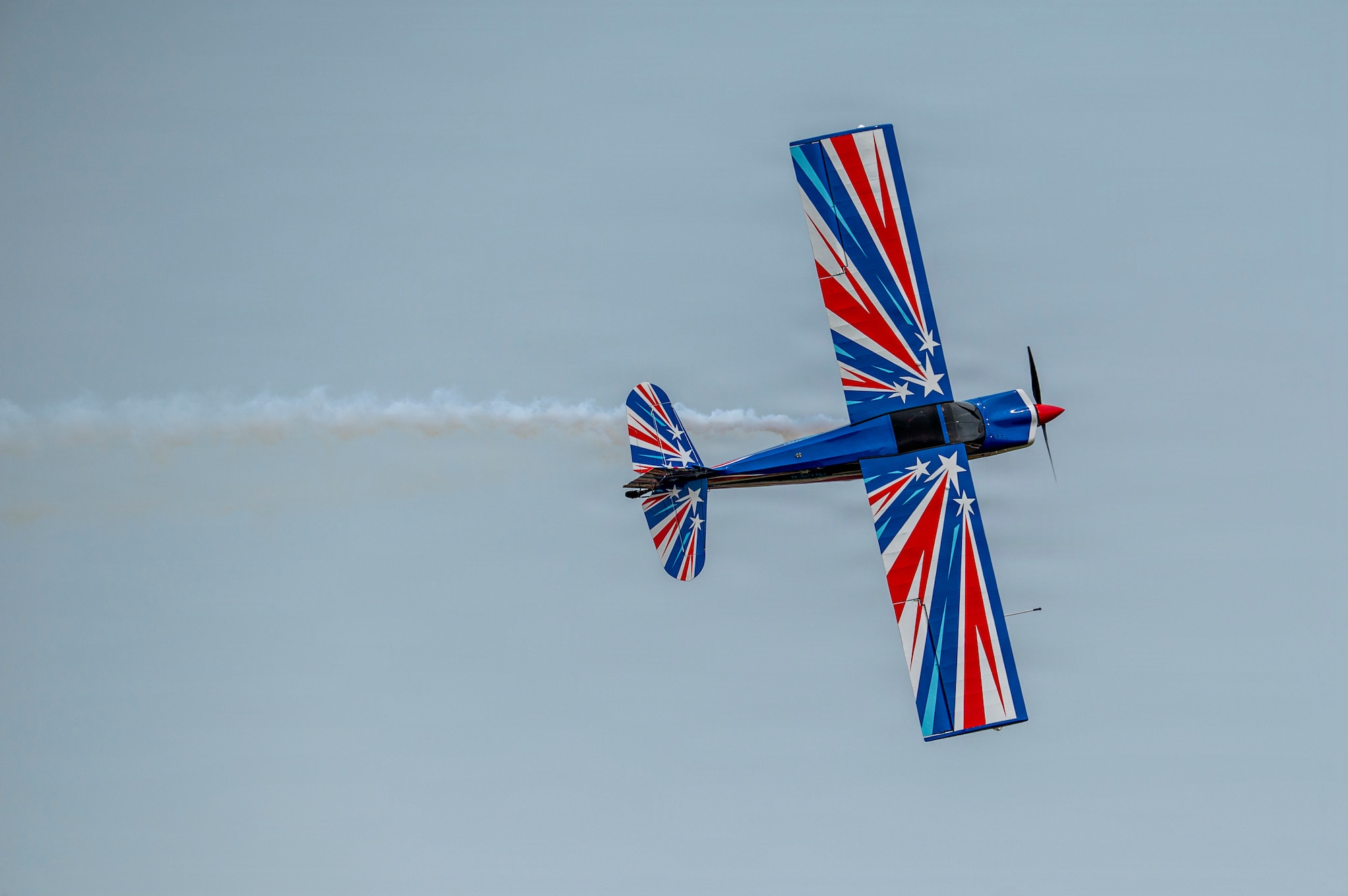 A Decathlon aerobatic aircraft, piloted by RJ Gritter, performs an aerial demonstration maneuver during the 2026 Defenders of Freedom Air & Space Show at Offutt Air Force Base, Nebraska, Aug. 9, 2026. DoF 2026 served as a free, public open house to foster strong community relations and express appreciation to the local Greater Omaha community. (U.S. Air Force photo by Senior Airman Matthew Arachikavitz)