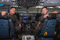 A photo of two Airmen smiling inside of a C-17 Globemaster III