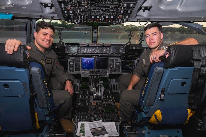 A photo of two Airmen smiling inside of a C-17 Globemaster III