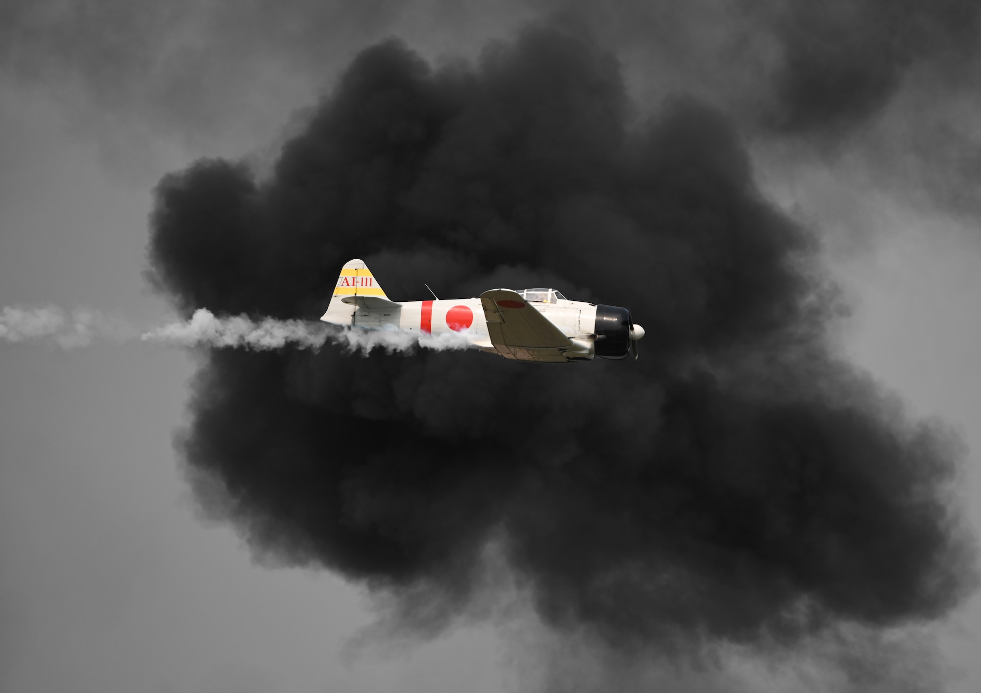 A historic Mitsubishi A6M flies in formation during the 2026 Defenders of Freedom Air & Space Show at Offutt Air Force Base, Nebraska, Aug. 9, 2026. The event highlighted the historic evolution of military aviation, bridging the gap between legacy heritage platforms and modern combat capabilities to preserve and share military history. (U.S. Air Force Photo by Airman 1st Class Charles Bolden)