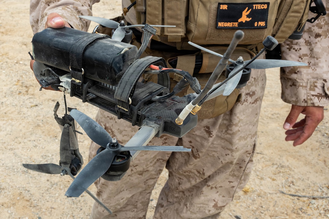 A simulated enemy Unmanned Aerial System is displayed after being neutralized with small arms fire during Counter-small Unmanned Aerial System training as part of Service Level Training Exercise 4-26 at Training Area Prospect, Marine Corps Air Ground Combat Center, Twentynine Palms, California, July 17, 2026. With the debut of C-sUAS lanes at the Combat Center, Marines recognize and respond to unmanned aerial threats by employing emerging tactics, techniques, procedures, and maintaining a C-sUAS mindset in every operation, all while preserving the fundamentals that make rifle squads survivable and lethal. SLTE is a premier training event that ensures the Marine Corps remains a highly lethal, adaptable force capable of dominating the future multi-domain fight. (U.S. Marine Corps photo by Lance Cpl. Cody Fitzgerald)