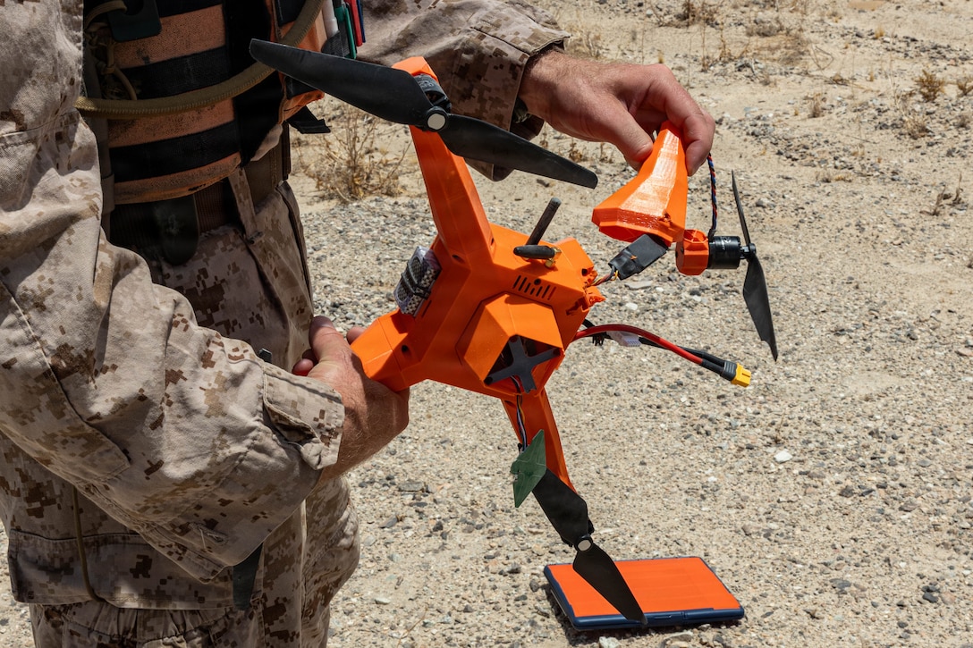 A simulated enemy Unmanned Aerial System is displayed after being neutralized with small arms fire during Counter-small Unmanned Aerial System training as part of Service Level Training Exercise 4-26 at Training Area Prospect, Marine Corps Air Ground Combat Center, Twentynine Palms, California, July 17, 2026. With the debut of C-sUAS lanes at the Combat Center, Marines recognize and respond to unmanned aerial threats by employing emerging tactics, techniques, procedures, and maintaining a C-sUAS mindset in every operation, all while preserving the fundamentals that make rifle squads survivable and lethal. SLTE is a premier training event that ensures the Marine Corps remains a highly lethal, adaptable force capable of dominating the future multi-domain fight. (U.S. Marine Corps photo by Lance Cpl. Cody Fitzgerald)
