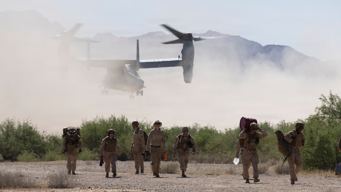 U.S. Marines assigned to Marine Aviation Weapons and Tactics Squadron One (MAWTS-1) carry supplies to a Forward Arming and Refueling Point during Final Exercise as part of Weapons and Tactics Instructor course 2-26, at Stoval Airfield, near Dateland, Arizona, April 24, 2026.WTI is a seven-week training event hosted by MAWTS-1 which emphasizes operational integration of the seven functions of Marine aviation in support of the Marine Air Ground Task Force, Joint and Coalition Forces. (U.S. Marine Corps photo by Lance Cpl. Alexander Vaughn)