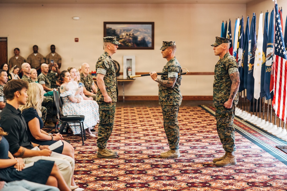 U.S. Marine Corps Col. Phillip T. Ash, left, commanding officer, Sgt. Maj. David M. Potter, the outgoing sergeant major and Sgt. Maj. Thomas J. Yeaman, the incoming sergeant major, all with Marine Aviation Weapons and Tactics Squadron One, stand at attention during a relief and appointment ceremony at Marine Corps Air Station Yuma, Arizona, June 26, 2026. The historic post and relief ceremony is a time-honored tradition within the U.S. Marine Corps, allowing the new appointed Sergeant Major the opportunity to introduce himself to the Marines now under his charge. (U.S. Marine Corps photo by Cpl. Micah Thompson)