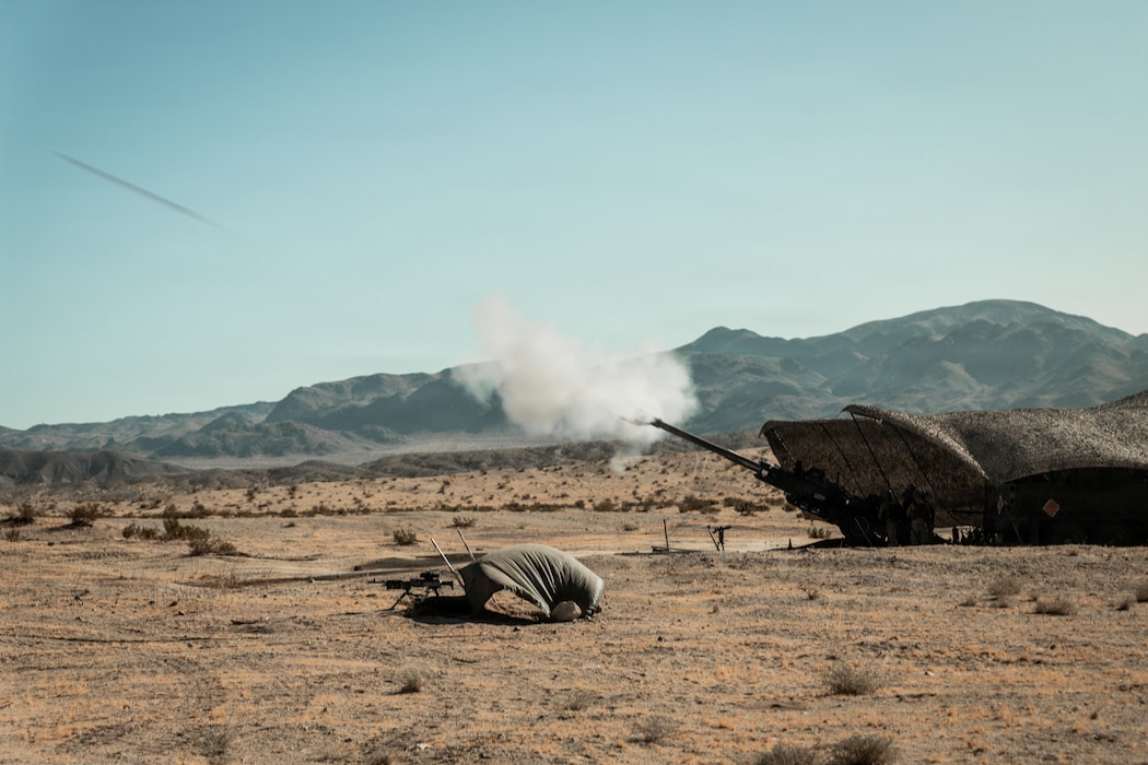 An M777 Howitzer fires a round during an observation shoot as part of Service Level Training Exercise 4-26 at Marine Corps Air Ground Combat Center, Twentynine Palms, California, July 29, 2026. SLTE is a premier training event that ensures the Marine Corps remains a highly lethal, adaptable force capable of dominating the future multi-domain fight. (U.S. Marine Corps photo by Lance Cpl. Dominic Spence)