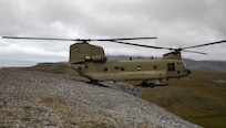 A CH-47 Chinook performs a pinnacle landing in Alaska.