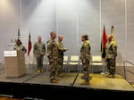 U.S. Army Col. Ben Wynn, commander of the 30th Mobile Brigade Combat Team, gives U.S. Army 1st Lt. Rebecca Benjamin, executive officer for the 230th Brigade Support Battalion, Augmentation Com., the North Carolina flag in Greensboro, North Carolina, Aug. 7, 2026. The 230th Brigade Support Battalion will be supporting U.S. CENTCOM's Operation Spartan Shield, a contingency operation in Southwest Asia and the Middle East. Photo by Lt. Col. Ellis Parks.