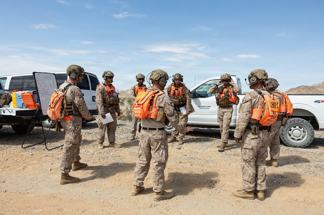 U.S. Marines with Tactical Training and Exercise Control Group, Marine Corps Air Ground Combat Center, gather for a brief during Counter-small Unmanned Aerial System training as part of Service Level Training Exercise 4-26 at Training Area Prospect, MCAGCC, Twentynine Palms, California, July 17, 2026. With the debut of C-sUAS lanes at the Combat Center, Marines recognize and respond to unmanned aerial threats by employing emerging tactics, techniques, procedures, and maintaining a C-sUAS mindset in every operation, all while preserving the fundamentals that make rifle squads survivable and lethal. SLTE is a premier training event that ensures the Marine Corps remains a highly lethal, adaptable force capable of dominating the future multi-domain fight. (U.S. Marine Corps photo by Lance Cpl. Cody Fitzgerald)