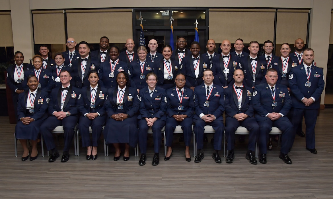 People in U.S. Air Force uniforms pose for a group photo.