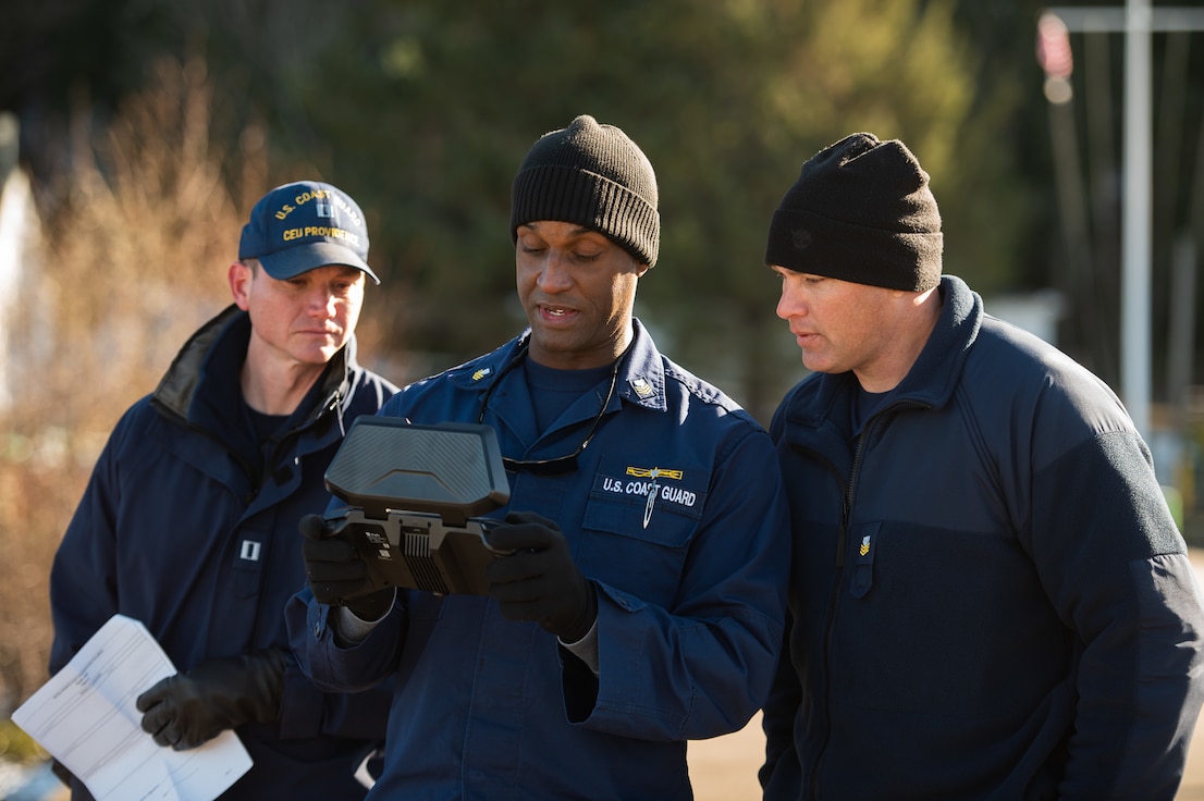 U.S. Coast Guard members look at the unmanned aircraft system controller while practicing how to pilot the UAS in Astoria, Oregon, Feb. 24, 2023. The Coast Guard is piloting a new UAS system that will be used in conjunction with the Coast Guard's 11 statutory missions. (U.S. Coast Guard photo by Petty Officer 3rd Class Diolanda Caballero)
