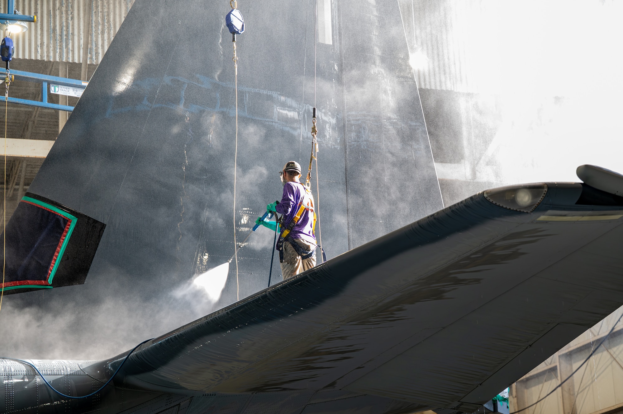 A Hurlburt Field wash rack contractor pressure washes the tail of an MC-130J Commando II assigned to the 1st Special Operations Wing at Hurlburt Field, Florida, July 2, 2026.