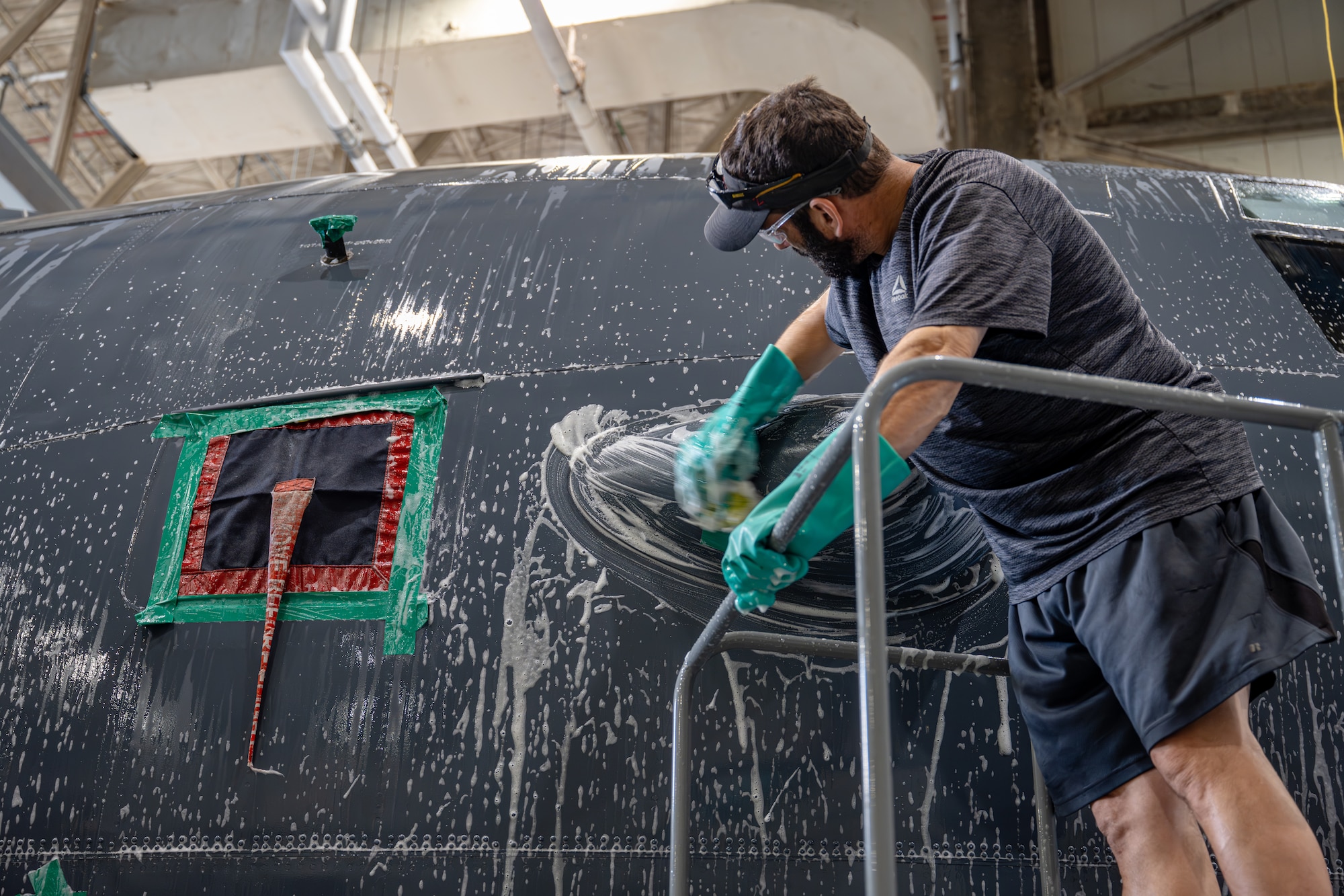 A Hurlburt Field wash rack contractor scrubs the exterior of an MC-130J Commando II assigned to the 1st Special Operations Wing at Hurlburt Field, Florida, July 2, 2026.