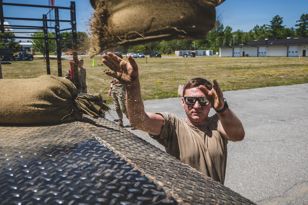 Staff Sgt. Robert Mooney loads heavy sandbags into a cargo truck during the 101st Air Refueling Wing Security Forces Squadron Best Defender competition, Bangor, ME, July 27th, 2026.