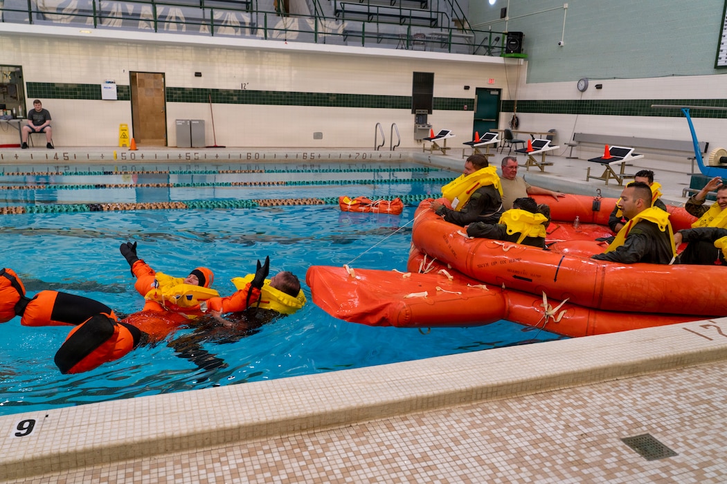 A SERE student drags their teammate through the water toward a life raft during Survival, Evasion, Resistance, and Escape (SERE) training in Bangor, Maine, Aug. 8, 2026.