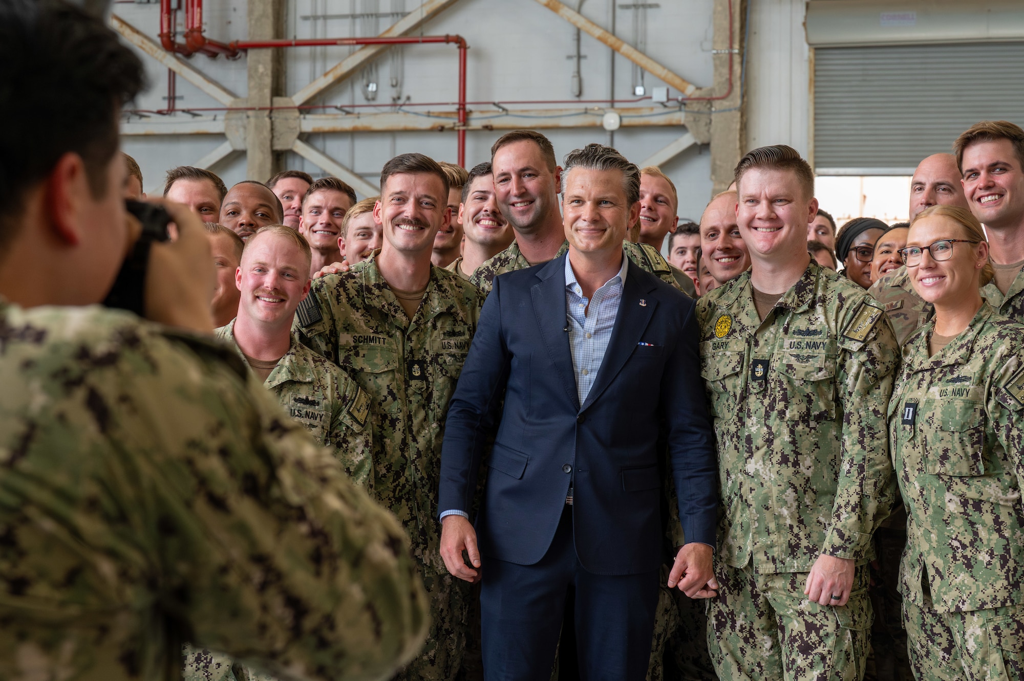 A man gathers with a group of people for a photo.