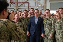 A man gathers with a group of people for a photo.
