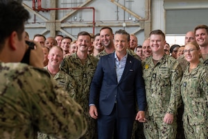 A man gathers with a group of people for a photo.