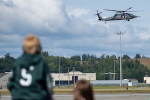A U.S. Air Force HH-60W Jolly Green II aircraft assigned to the 210th Rescue Squadron, Alaska Air National Guard, demonstrates its rescue capabilities during the Joint Forces Demonstration at the Arctic Thunder Open House at Joint Base Elmendorf-Richardson, Alaska, Aug. 7, 2026. Commanders will employ units equipped with the HH-60W to recover isolated personnel from hostile or denied territory, day or night, in adverse weather, and in a variety of threat environments from terrorist to chemical, biological, radiological, and nuclear. (U.S. Air Force photo by Airman 1st Class Thomas Polk)