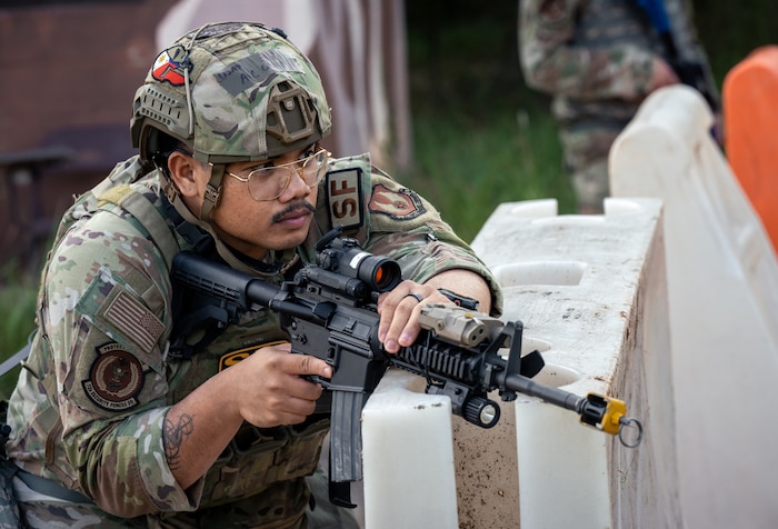 Airman leaning over barrier