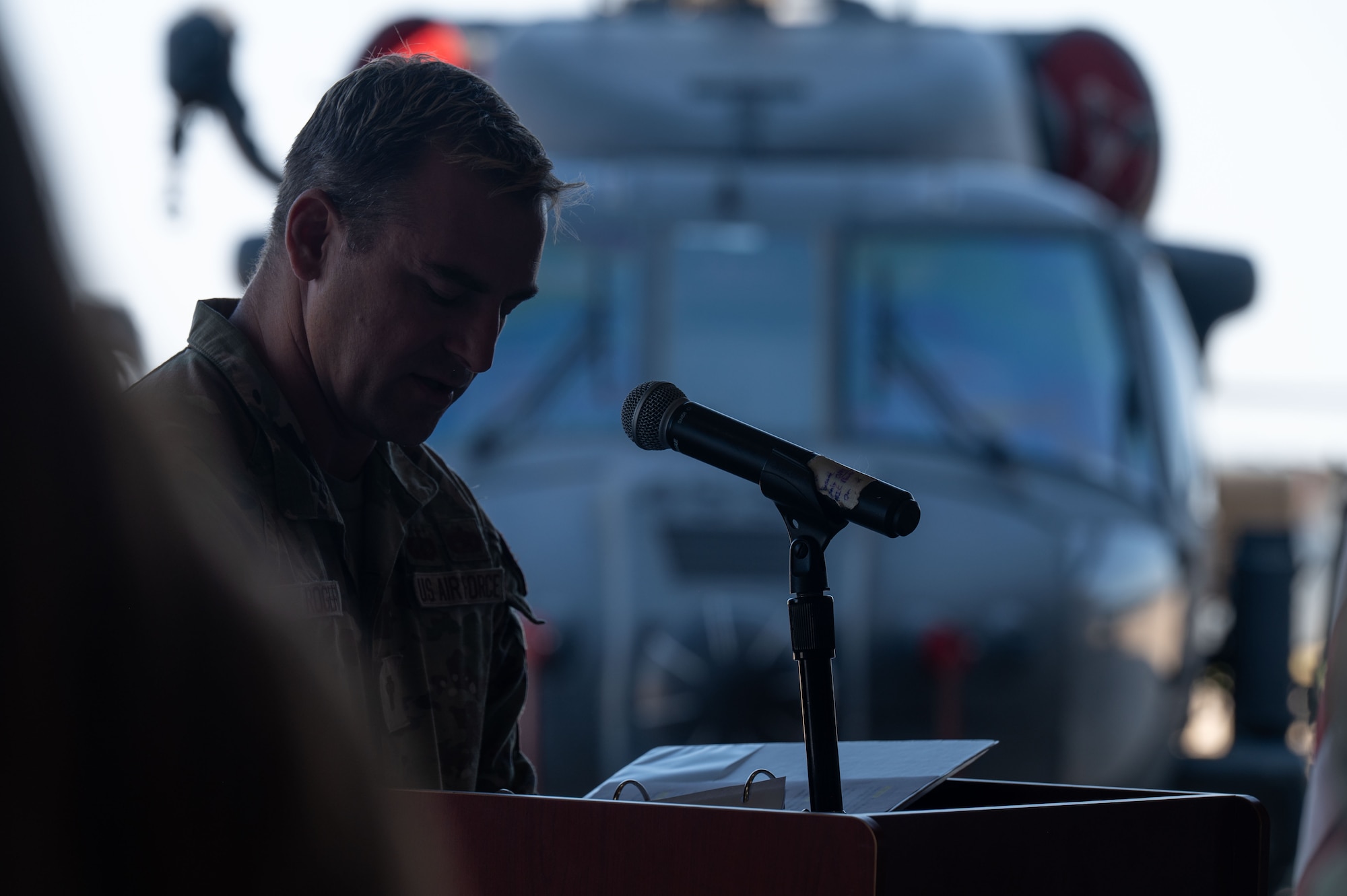 U.S. Air Force Capt. Brandon Roger, 355th Wing chaplain, leads a prayer during the 55th Rescue Generation Squadron inactivation ceremony at Davis-Monthan Air Force Base, Arizona, Aug. 10, 2026. The 55th RGS maintained the HH-60W Jolly Green II, the Air Force’s premier combat rescue helicopter, designed to perform personnel recovery missions in contested and hostile environments. (U.S. Air Force photo by Airman 1st Class Jaden Kidd)