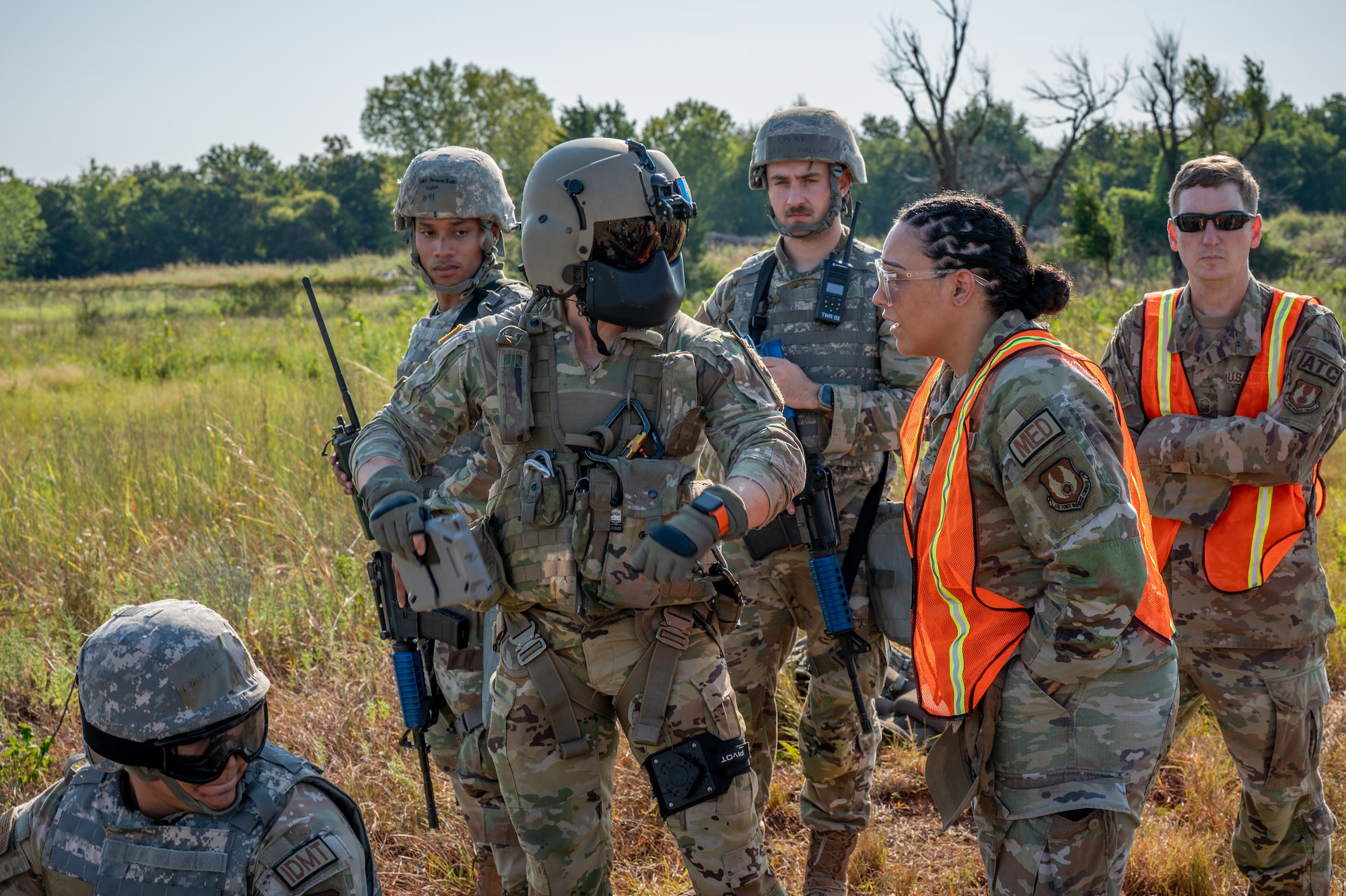Airmen talking to Army helicopter personnel