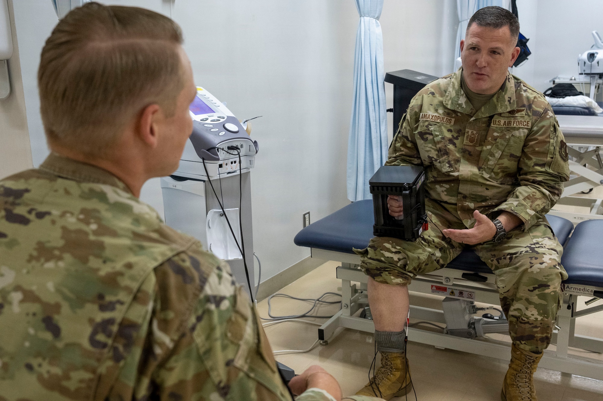 U.S. Air Force Staff Sgt. Keven Craig, left, a physical therapist assigned to the 35th Operational Medical Readiness Squadron, demonstrates rehabilitation equipment to Chief Master Sgt. Chief Master Sergeant Jason Amaxopulos, 35th Fighter Wing command chief, during a Wild Weasel Walkthrough at Misawa Air Base, Japan, Aug. 10, 2026.
