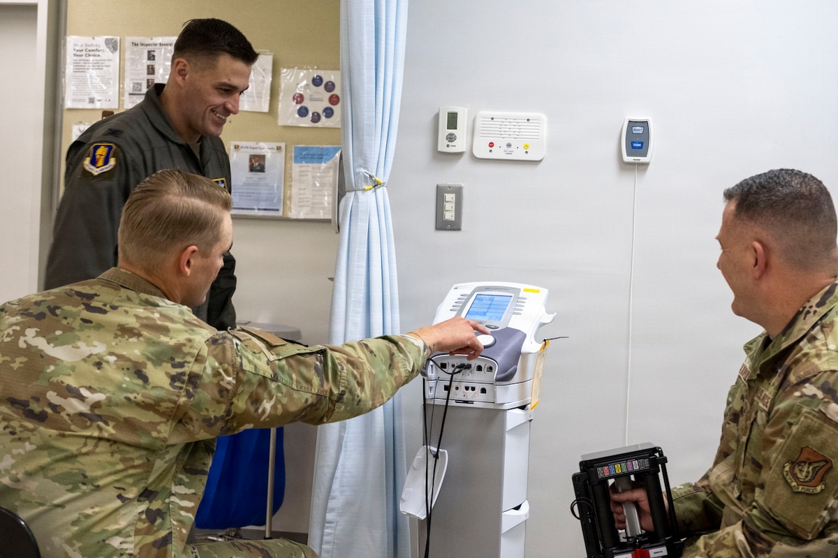 U.S. Air Force Staff Sgt. Keven Craig, center, a physical therapist assigned to the 35th Operational Medical Readiness Squadron, explains vital signs on rehabilitation equipment to Col. Oliver Lause, 35th Fighter Wing commander (right) and Chief Master Sgt. Chief Master Sergeant Jason Amaxopulos, 35th Fighter Wing command chief (left), during a Wild Weasel Walkthrough at Misawa Air Base, Japan, Aug. 10, 2026.