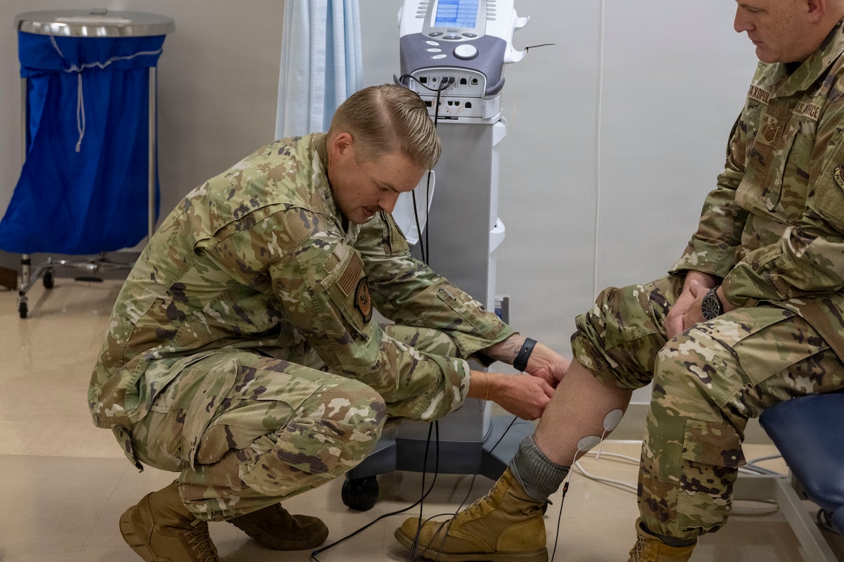 U.S. Air Force Staff Sgt. Keven Craig, left, a physical therapist assigned to the 35th Operational Medical Readiness Squadron, places electrode pads on the lower leg of Chief Master Sgt. Jason Amaxopulos, 35th Fighter Wing command chief, during a Wild Weasel Walkthrough at Misawa Air Base, Japan, Aug. 10, 2026.