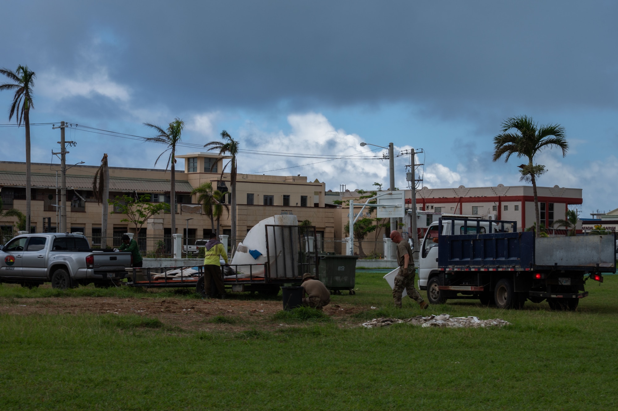 U.S. Airmen assigned to the 21st Combat Air Base Squadron clear heavy storm debris alongside local residents at Saipan, Commonwealth of the Northern Mariana Islands, June 22, 2026. Working in support of the Federal Emergency Management Agency, 21st CABS personnel integrated directly with civil and local officials in the CNMI to accelerate Typhoon Sinlaku recovery efforts. Partnering with domestic communities during disaster response is a key vehicle through which the Department of War builds trust and ensures a unified, efficient recovery. (U.S. Air Force photo by Senior Airman Alondra Cristobal)