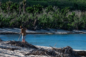 U.S. Air Force Senior Airman Evan Bland, 21st Combat Air Base Squadron vehicle mechanic, clears storm debris from a local park on Tinian, Commonwealth of the Northern Mariana Islands, June 11, 2026. The 21st CABS utilized multi-skilled, Mission-Ready Airmen to execute cross-functional tasks, restoring vital public spaces in the CNMI following Typhoon Sinlaku. The Department of War remains committed to supporting civil authorities, working in close coordination with the Federal Emergency Management Agency and local territorial officials to deliver a unified response. (U.S. Air Force photo by Senior Airman Alondra Cristobal)
