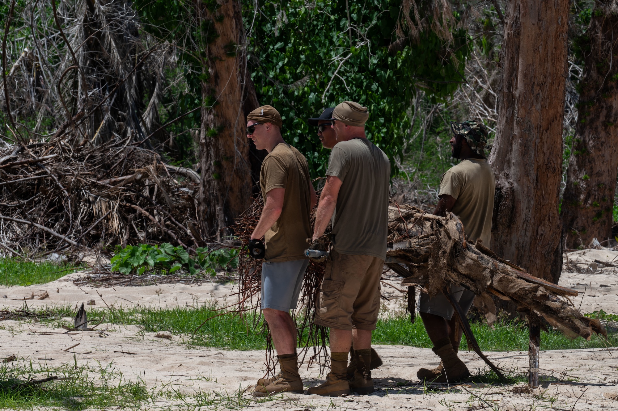 U.S. Airmen assigned to the 21st Combat Air Base Squadron clear a fallen tree from a public roadway on Tinian, Commonwealth of the Northern Mariana Islands, June 11, 2026. The 21st CABS supported disaster recovery efforts led by the Federal Emergency Management Agency in the wake of Typhoon Sinlaku’s major infrastructure damage across the CNMI. Fostering strong partnerships with local communities during crisis response operations is a primary vehicle through which the Department of War demonstrates U.S. commitment to regional stability. (U.S. Air Force photo by Senior Airman Alondra Cristobal)