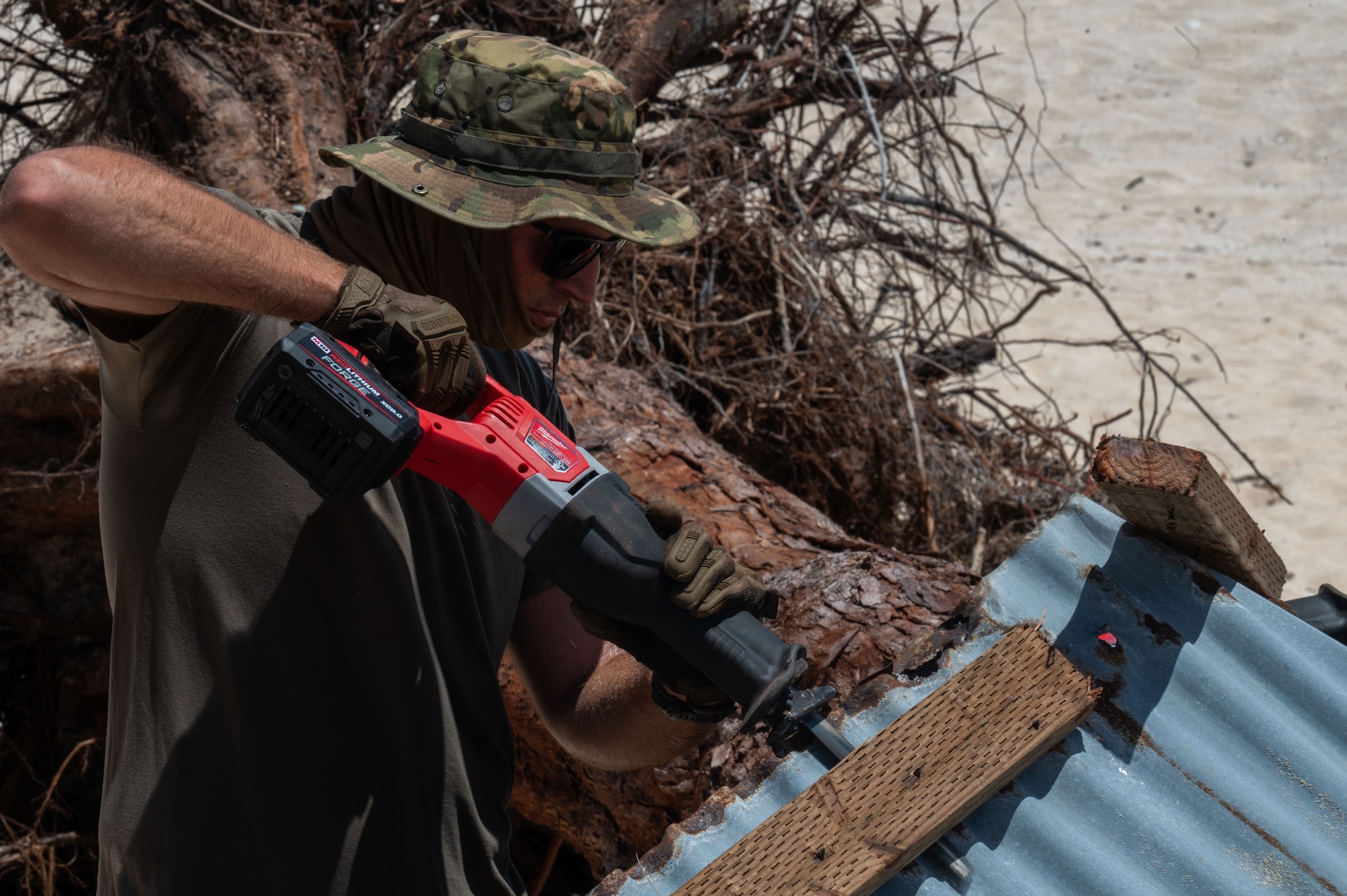 U.S. Air Force Staff Sgt. Matthew Dunst, 21st Combat Air Base Squadron structural journeyman, cuts through compromised wooden and metal structural beams on Tinian, Commonwealth of the Northern Mariana Islands, June 10, 2026. Following major infrastructure damage caused by Typhoon Sinlaku, the 21st CABS deployed to the CNMI to execute Defense Support of Civil Authorities missions. All Department of War response efforts are conducted in direct support of the Federal Emergency Management Agency and local civil officials to ensure the rapid restoration of safe public spaces. (U.S. Air Force photo by Senior Airman Alondra Cristobal)