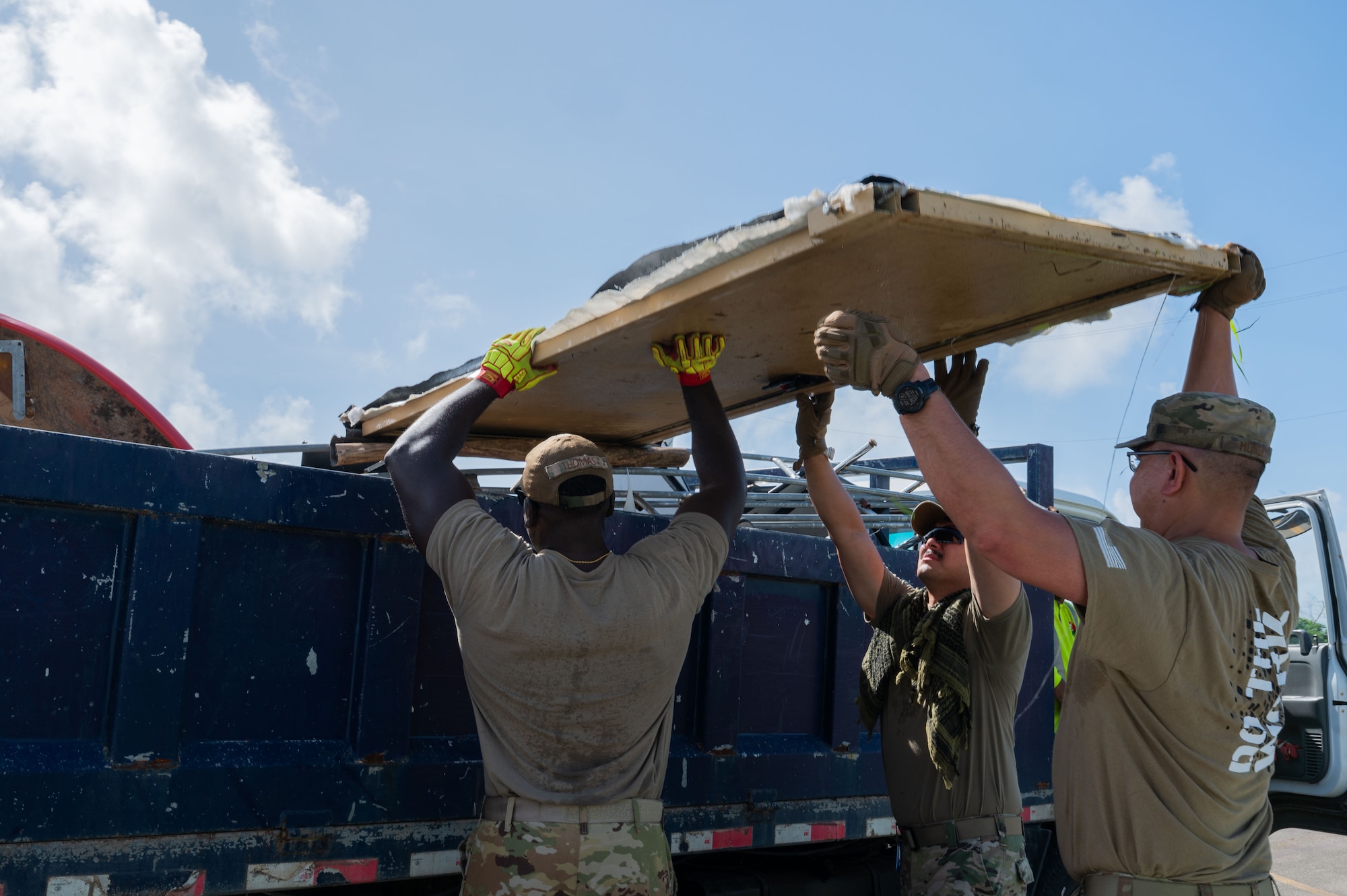 U.S. Airmen assigned to the 21st Air Expeditionary Wing clear Typhoon Sinlaku wreckage at Saipan, Commonwealth of the Northern Mariana Islands, June 25, 2026. The 21st AEW partnered with local contractors to remove hazardous debris from residential neighborhoods and public facilities across the CNMI. All Department of War disaster recovery efforts are conducted in close coordination with the Federal Emergency Management Agency and local civil officials to ensure a unified and efficient response. (U.S. Air Force photo by Senior Airman Alondra Cristobal)