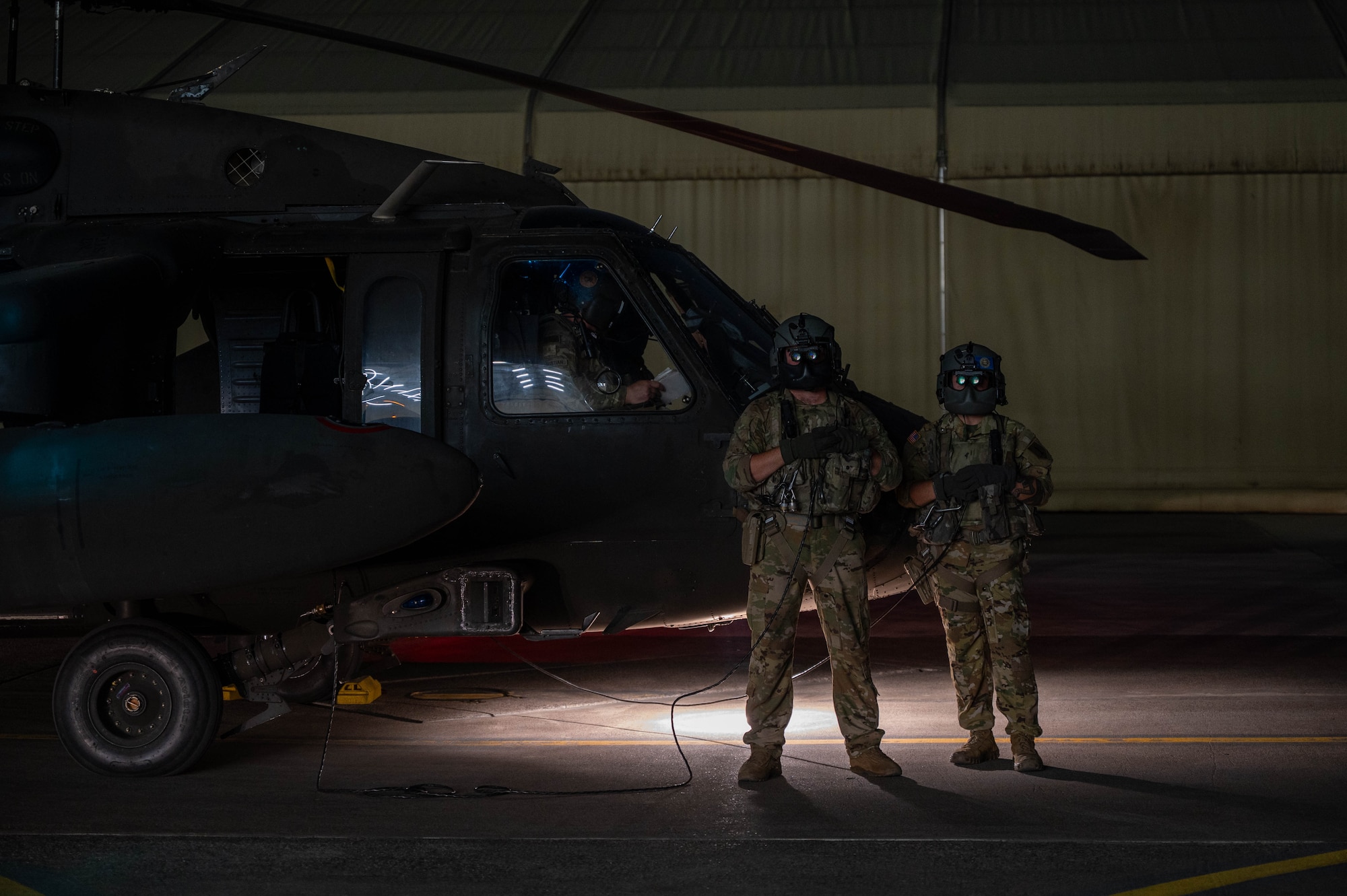 U.S. Army Sgt. Tyler Thompson, left, and Spc. Matthew Warner, Alpha Company, 3rd Assault Helicopter Battalion, 1st Aviation Combat Brigade crew chiefs, pose for a photo before routine night flight operations at Incirlik Air Base, Türkiye, July 31, 2026.  Routine flight operations help strengthen readiness and reinforce regional deterrence by ensuring U.S. and Allied forces can rapidly respond to emerging threats.